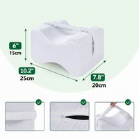 Coussin genoux ergonomique blanc (25×20×15 cm) avec sangle de maintien et housse zippée amovible ; dimensions et texture visibles.